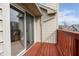 Balcony with a sliding glass door and red wooden railing overlooking the surrounding buildings at 3038 Wildcat Ln, Indianapolis, IN 46203