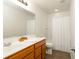 Well-lit bathroom featuring a large mirror, wood cabinet, and shower with white curtain at 3038 Wildcat Ln, Indianapolis, IN 46203