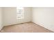 Minimalist bedroom featuring a neutral carpet, window, and outlets on the wall at 3038 Wildcat Ln, Indianapolis, IN 46203