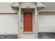 Close up of the front entrance of the townhouse with a red door, number 3038, and door lock at 3038 Wildcat Ln, Indianapolis, IN 46203