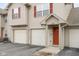 Townhouse exterior with a red door and two-car garage, showcasing curb appeal at 3038 Wildcat Ln, Indianapolis, IN 46203