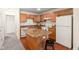 Functional kitchen with center island, wooden cabinets, and tiled floors at 3038 Wildcat Ln, Indianapolis, IN 46203
