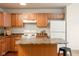 Well-lit kitchen with wooden cabinets, island, and modern appliances at 3038 Wildcat Ln, Indianapolis, IN 46203