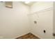Practical laundry room with wooden floors, shelving, and visible water connections at 3038 Wildcat Ln, Indianapolis, IN 46203
