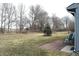 Expansive backyard with mature trees, lawn and small patio area at 400 Lockerbie Ln, Pittsboro, IN 46167