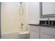 The bathroom is equipped with a shower over bath, and a vanity with black countertop at 400 Lockerbie Ln, Pittsboro, IN 46167