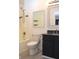 Bathroom with a shower-tub combo, toilet, and vanity with black granite countertop and framed mirror at 400 Lockerbie Ln, Pittsboro, IN 46167