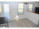 Bright dining area features wood floors, modern lighting, and access to the backyard, perfect for gatherings at 400 Lockerbie Ln, Pittsboro, IN 46167