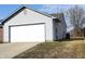 Garage of home with vinyl siding and large garage door at 400 Lockerbie Ln, Pittsboro, IN 46167