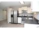 Kitchen featuring stainless steel appliances, white cabinets, and black countertops at 400 Lockerbie Ln, Pittsboro, IN 46167