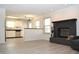 View of the living room featuring the fireplace and open layout into the kitchen at 400 Lockerbie Ln, Pittsboro, IN 46167