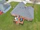An aerial view of a well-maintained backyard with a wooden deck, outdoor furniture, and a lush green lawn at 4019 Santa Clara Dr, Greenwood, IN 46142