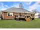 Exterior backyard view, showcasing the deck off the house, and the brick house's architectural details at 4019 Santa Clara Dr, Greenwood, IN 46142