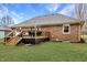 Backyard featuring a wooden deck accessible from the home, overlooking the well-maintained lawn at 4019 Santa Clara Dr, Greenwood, IN 46142