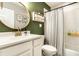 Stylish bathroom features a vanity, round mirror, and a tub with shower, blending convenience and aesthetics at 4019 Santa Clara Dr, Greenwood, IN 46142