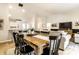 Open concept dining area with a wooden table, black chairs, and views of the kitchen and living area at 4019 Santa Clara Dr, Greenwood, IN 46142
