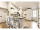 Well-lit kitchen featuring white cabinets, a center island with seating, and modern stainless steel appliances at 4019 Santa Clara Dr, Greenwood, IN 46142