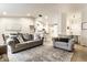 Open-concept living room features neutral decor, hardwood floors, and seamless flow into the kitchen area at 4019 Santa Clara Dr, Greenwood, IN 46142