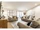 Bright, airy living room with neutral tones, stylish furnishings, and a sliding glass door to the deck at 4019 Santa Clara Dr, Greenwood, IN 46142