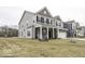 Charming two-story home with light gray siding, a brick facade, and a well-manicured front lawn at 4078 Omaha Dr, Bargersville, IN 46106