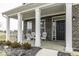 Inviting front porch featuring white columns, brick accents, and cozy seating, perfect for relaxing outdoors at 4078 Omaha Dr, Bargersville, IN 46106