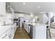 Modern white kitchen with stainless steel appliances, island sink, and sleek countertops at 4078 Omaha Dr, Bargersville, IN 46106