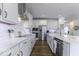 Modern kitchen featuring white cabinets, stainless steel appliances, and a large island with a sink at 4078 Omaha Dr, Bargersville, IN 46106
