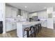 Modern kitchen with white cabinetry, stainless steel appliances, hardwood floors, and a large center island at 4078 Omaha Dr, Bargersville, IN 46106