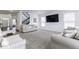 Bright living room features plush carpet, comfortable seating, staircase, and a wall-mounted television at 4078 Omaha Dr, Bargersville, IN 46106
