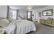 Bright main bedroom features carpeted floors, dresser, desk and soft, natural light at 4078 Omaha Dr, Bargersville, IN 46106