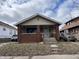 Charming single-Gathering home featuring a cozy front porch with brick detail and inviting curb appeal at 410 N Euclid Ave, Indianapolis, IN 46201