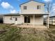 Large backyard featuring patio area, mature trees, and outdoor seating space at 415 W Gimber St, Indianapolis, IN 46225