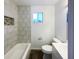 Clean, well-lit bathroom with tiled tub, modern vanity, and contemporary fixtures at 415 W Gimber St, Indianapolis, IN 46225