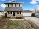 Charming two-story home with stone accents, well-maintained lawn, and attached garage at 415 W Gimber St, Indianapolis, IN 46225