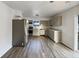 Updated kitchen features stainless steel appliances, modern cabinets, and wood-look flooring at 415 W Gimber St, Indianapolis, IN 46225