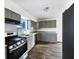 Well-lit kitchen with stainless steel appliances, and stylish wood grain flooring at 415 W Gimber St, Indianapolis, IN 46225