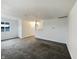 Open concept living room features neutral paint, plush carpet, and a view into the kitchen at 415 W Gimber St, Indianapolis, IN 46225