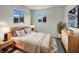 Serene main bedroom with ample light, soft rug, stylish furnishings, and modern accents at 415 W Gimber St, Indianapolis, IN 46225