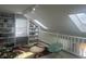 Attic space with built-in shelving, natural light, and a cozy reading nook with a chair at 4418 Tarragon Dr, Indianapolis, IN 46237