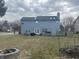 Expansive backyard featuring a deck, fire pit, and ample green space for outdoor enjoyment and entertainment at 4418 Tarragon Dr, Indianapolis, IN 46237