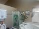 Bathroom featuring a corner tub, privacy shutters, glass shower stall, and decorative accents at 4418 Tarragon Dr, Indianapolis, IN 46237