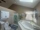 Bathroom featuring a corner tub, privacy shutters, glass shower stall, and decorative accents at 4418 Tarragon Dr, Indianapolis, IN 46237
