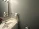 Bathroom featuring a modern vanity, mirror, and fixtures at 4418 Tarragon Dr, Indianapolis, IN 46237