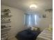 Cozy bedroom with two beds, decorative curtains, and shelving for decor at 4418 Tarragon Dr, Indianapolis, IN 46237