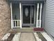 Charming front porch featuring decorative columns, elegant entry door, and lovely landscaping with river rock at 4418 Tarragon Dr, Indianapolis, IN 46237