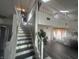 Bright open living room with two-story ceilings, hardwood floors, and staircase to second story at 4418 Tarragon Dr, Indianapolis, IN 46237