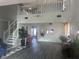 Open-concept living space featuring hardwood floors, two story ceilings, and staircase to second story at 4418 Tarragon Dr, Indianapolis, IN 46237
