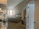 Bright main bedroom featuring a vaulted ceiling and large windows, with a luxurious upholstered bed frame at 4418 Tarragon Dr, Indianapolis, IN 46237