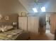 Bright main bedroom featuring a vaulted ceiling, skylights, and a doorway to the en suite bath at 4418 Tarragon Dr, Indianapolis, IN 46237