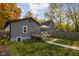Backyard features wooden deck, a grassy area, and fall foliage at 4818 Guilford Ave, Indianapolis, IN 46205